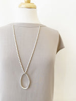 Long Adjustable Necklace with Worn Metal Oval